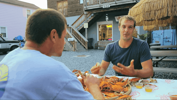 two men eating crabs