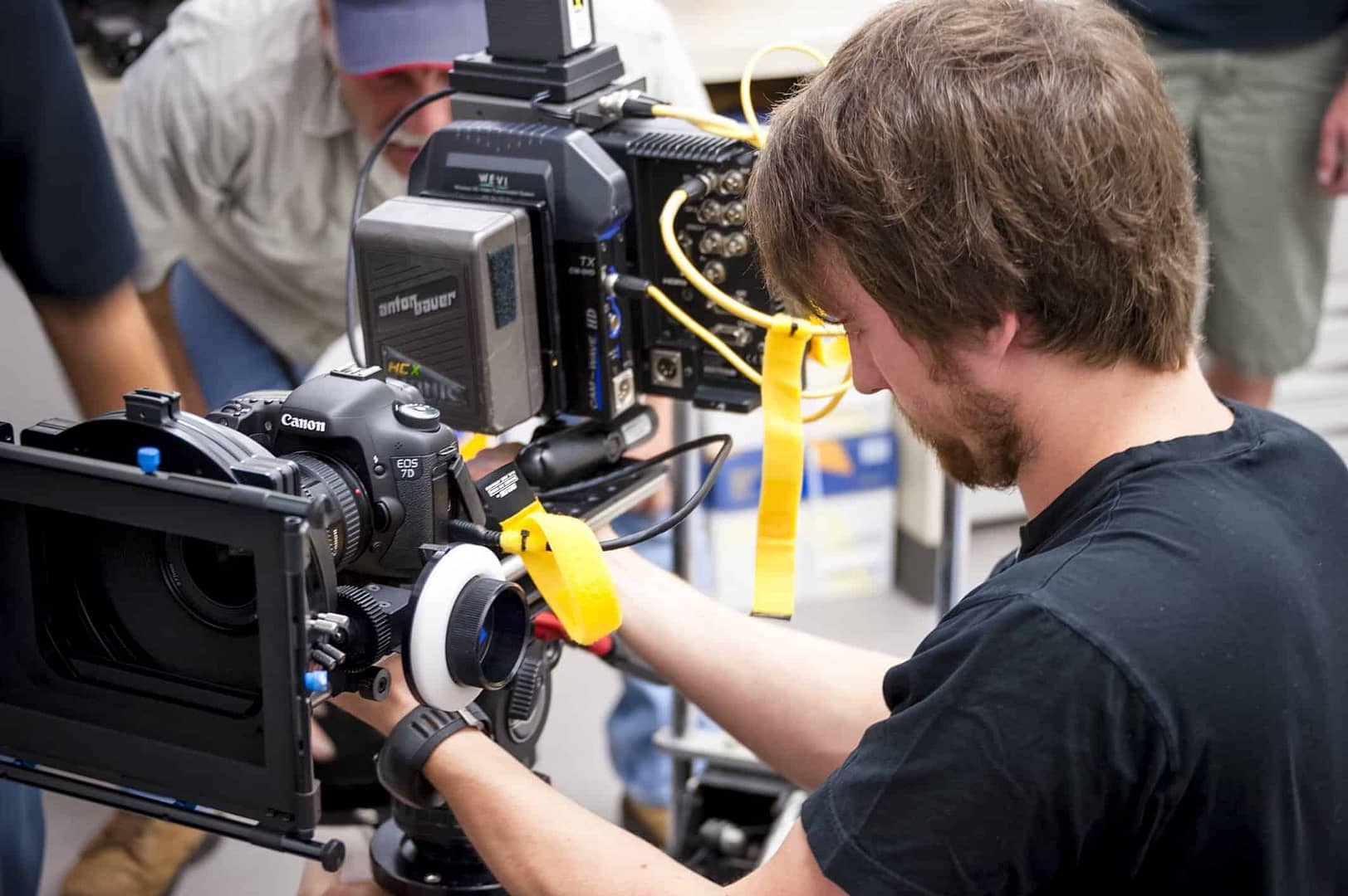 man working on a video camer