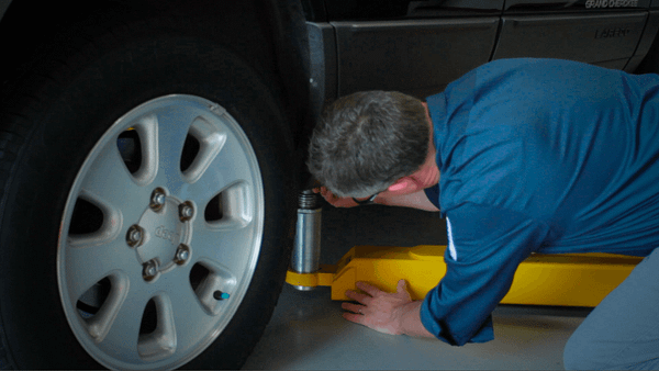 man repairing car