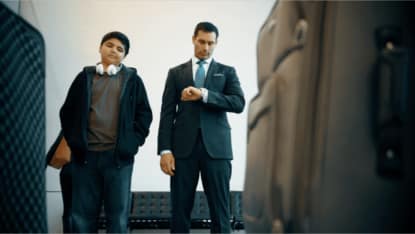 man and boy waiting at airport